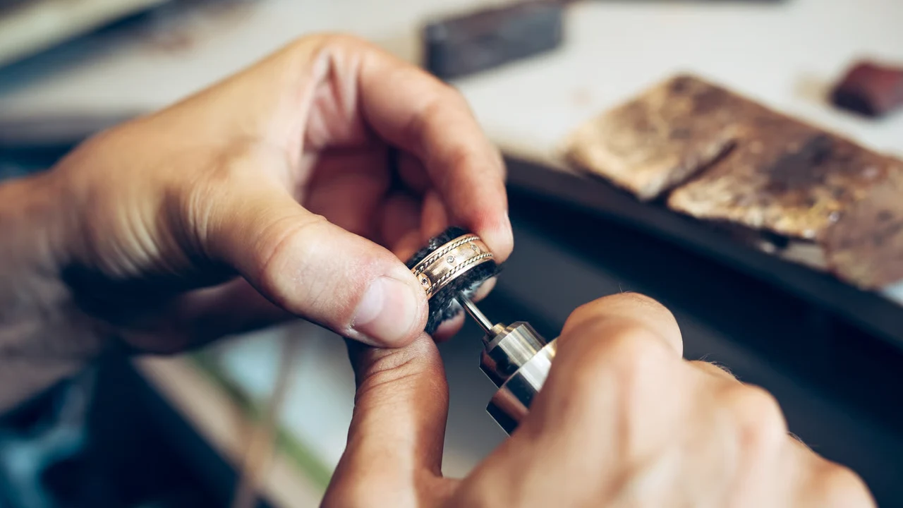 Crafting Gold_ Jeweler Polishing a Detailed Ring